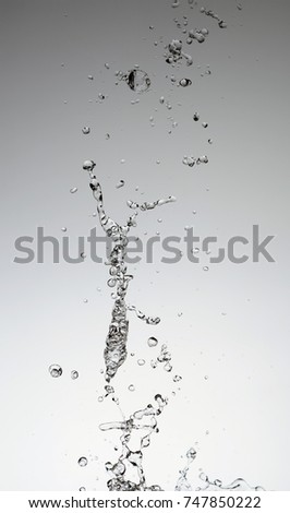 Moving water on white background, jets and drops