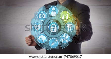 Faceless data analyst activating an analytics icon in a health care monitoring interface. Concept for actionable insight, reporting requirements, compliance and improvement in healthcare sector. Royalty-Free Stock Photo #747869017