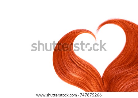 Red hair in shape of heart on white. Copy space