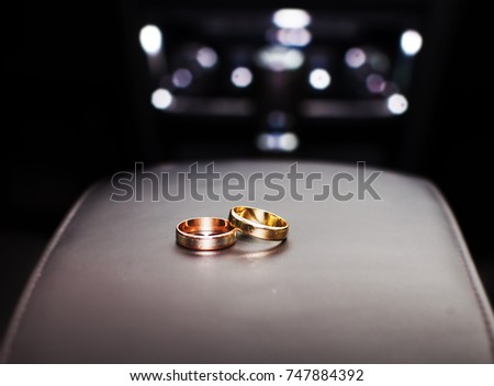 Two gold rings on white table