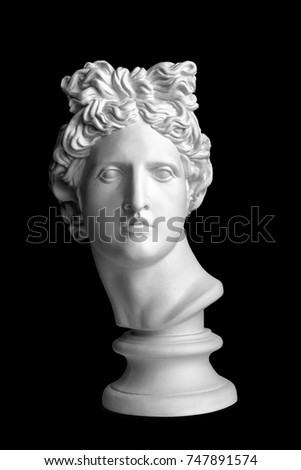 White head silhouette on black background. Gypsum statue of Apollo's head. Man. Statue. Isolated. Head. Apollo Belvedere. Black Lives Matter Royalty-Free Stock Photo #747891574