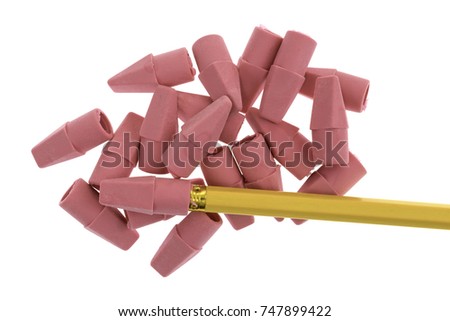 Top view of a group of synthetic rubber erasers with a yellow pencil on a white background.