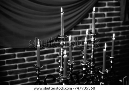 Halloween still life with candle on brick wall background