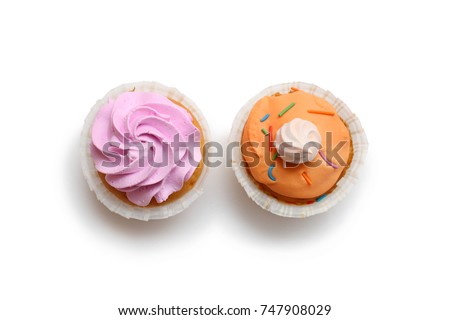 two cupcakes in icing with meringue on a white background