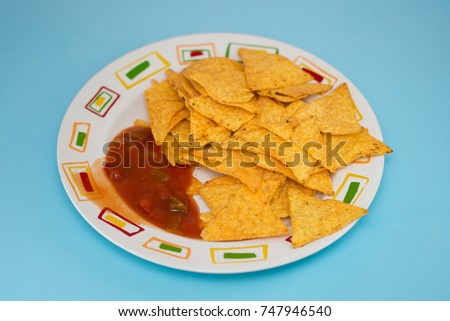 Tortilla with Salsa dip ,Potato chips and red sauce