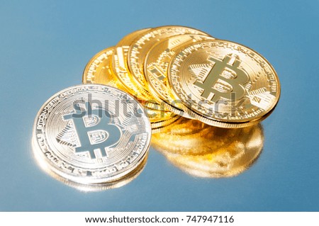 Several coins of bitcoins. Bright glow, toning and blurring. The concept of crypto currency