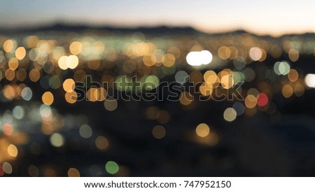 Bokeh lights from a city and traffic during a sunset evening sky