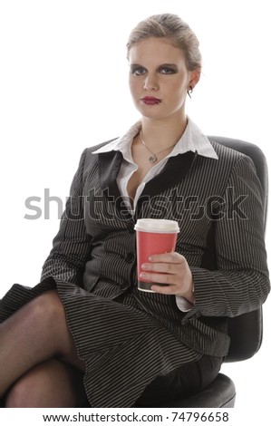 Young woman with lip piercing in a gray business suit and holding a paper coffee cup, isolated on a white background
