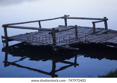 Waterside, wood pier made of bamboo in the morning at dawn, feeling lonely, isolated, and Thailand.