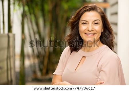 Mature Hispanic woman smiling. Royalty-Free Stock Photo #747986617