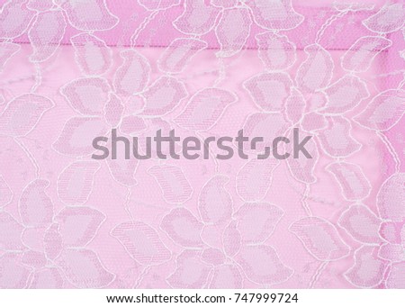 lace fabric texture. background.  a fine open fabric, typically one of cotton or silk, made by looping, twisting, or knitting thread in patterns and used especially for trimming garments.