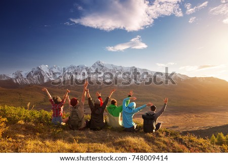 Group of six happy friends is having fun at mountain top
