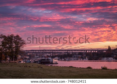 Dawn breaks over Lake Union sending colorful clouds across the sky