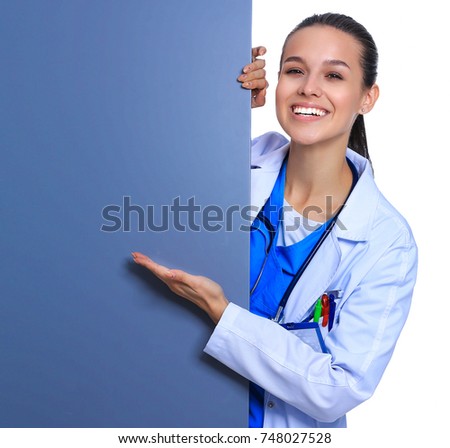 Female doctor with a blank billboard.