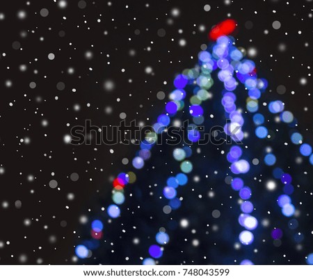 Abstract christmas background with blur bokeh defocused lights decoration on christmas tree.