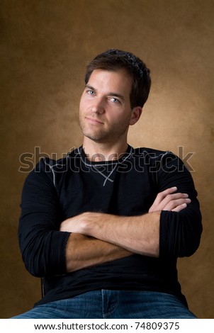 Handsome casual young man sitting in chair