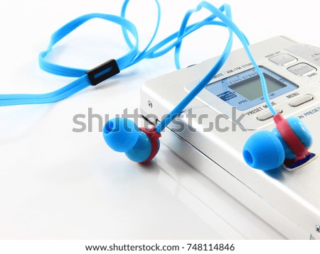 blue earphone with music player isolated on white background.Listening device. soft focus or selection focus.