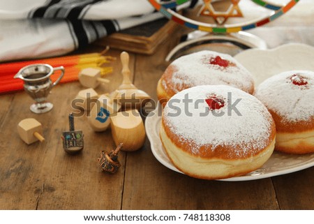 image of jewish holiday Hanukkah background with traditional spinnig top, doughnuts and menorah (traditional candelabra)
