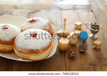 image of jewish holiday Hanukkah background with traditional spinnig top and doughnuts