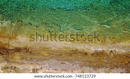Aerial drone, bird's eye view of tropical rocky seascape with turquoise and sapphire waters