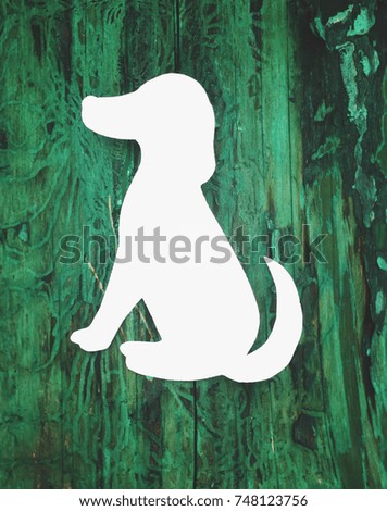 Wooden boards background. Aged colorful texture with white paper dog figure.