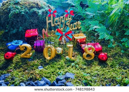 Christmas and Happy New Year 2018 Symbols from the moss green background.