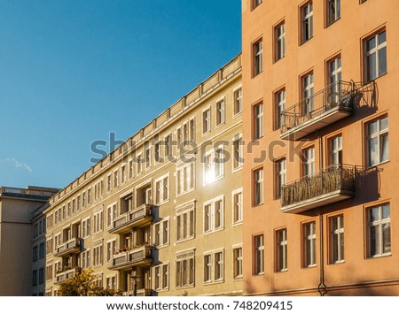 high contrasted picture of apartment building with lens flare in the windows