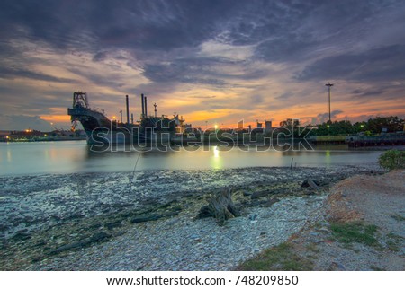 Ships dock alongside the shore, evening, sunset background
