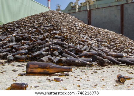 Glass pile brown bottles  in recycling  industry factory