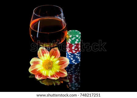Snifter with brandy and poker chips with flower