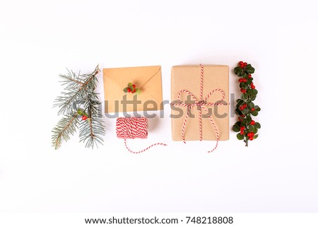 Christmas gift box collection with pine branch, envelope, ribbon, red berries for mock up template design. View from above. Flat lay, copy space