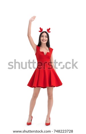 cheerful asian woman in deer costume waving to someone isolated on white
