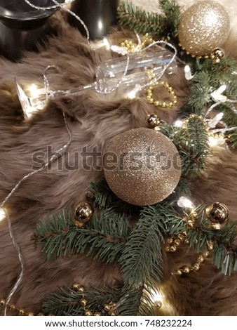 golden Christmas decorations on fur with lights