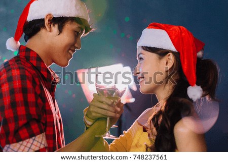 New Year party. Merry Christmas in nightclub. Friends celebrating together in santa hat.
