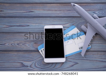 mock up screen of the mobile phone stores air tickets. Modern technology, applications for smartphones, online flat concepts. on a wooden background