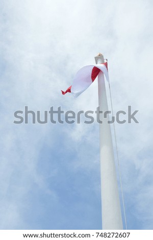 Indonesia's flag against blue sky