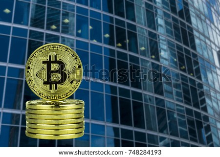 Golden bitcoins against the background of the business center