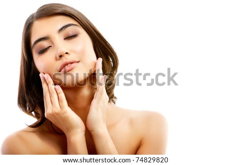 Portrait of pretty enjoying woman touching her face