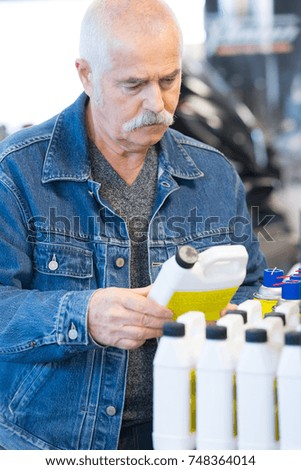 male customer holding lubricant container