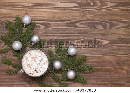 delicious hot cocoa with marshmallows on the Christmas table Christmas balls, fir branches knitted scarf warmth and comfort