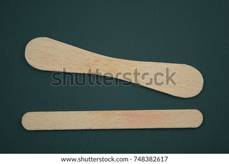 Wooden ice-cream sticks on black background