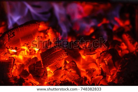 Glowing embers in hot red color, close up