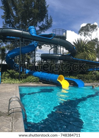 Vertical photography portrait picture view of water slides on an outdoor pool