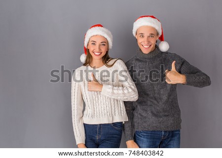 Young couple studio isolated on grey wall concept