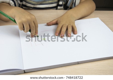pencil in the hands of a child