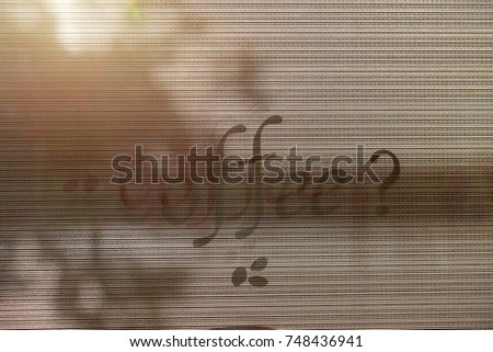 Coffee words on glass window frame closeup sunlight morning blur background
