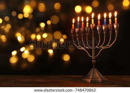 image of jewish holiday Hanukkah background with menorah (traditional candelabra) and burning candles Royalty-Free Stock Photo #748470862