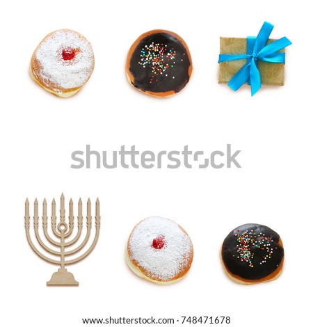 jewish holiday Hanukkah image with traditional doughnuts isolated and menorah (traditional candelabra) on white