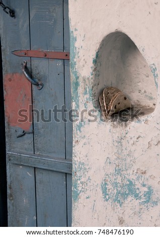 Indian Roti in hole in wall by door