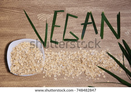 Oatmeal in a cup and the word vegan